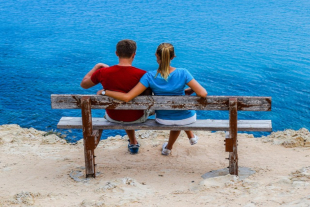 What All Women Deserve in a Relationship A couple sitting on a bench with the woman's arm around the shoulders of the man. Image by Dimitris Vetsikas from Pixabay.